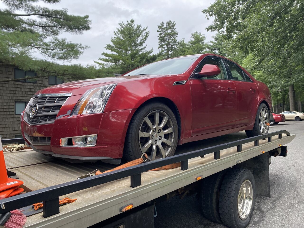 Junk car loaded on a Scrap Rats flatbed tow truck for free towing